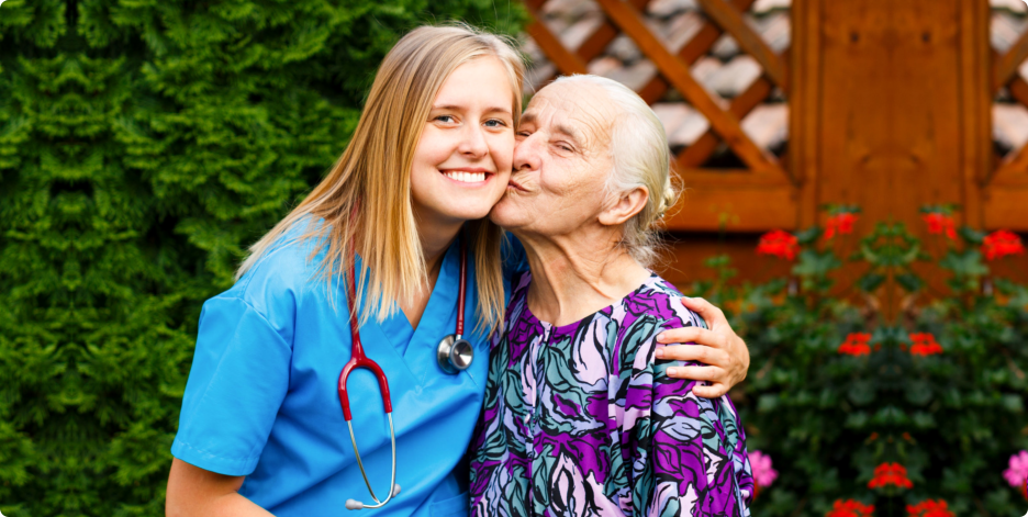 Elderly Woman kissing the caregiver
