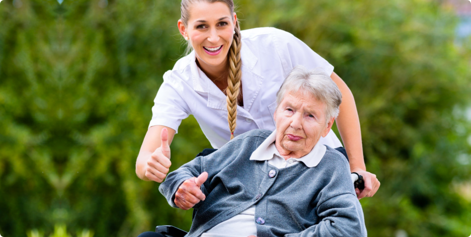 Old Woman and caregiver doing thumbs up